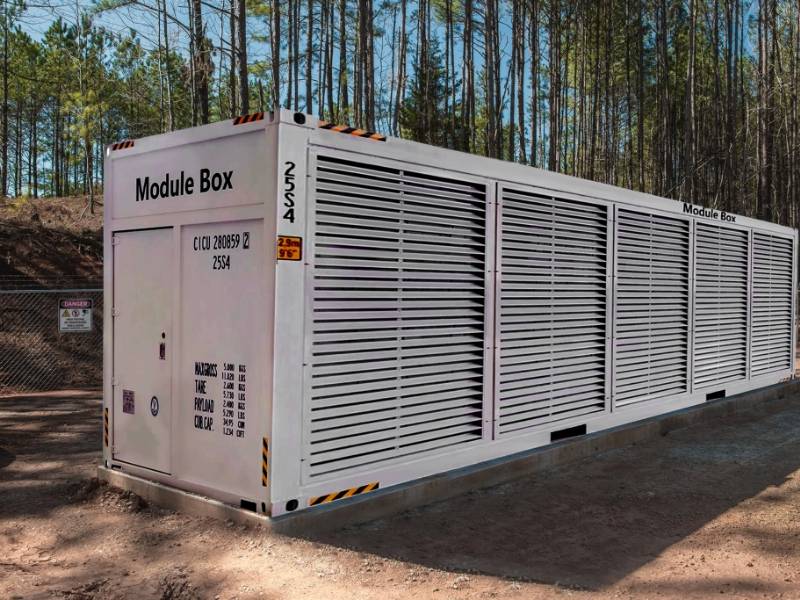 A mobile mining container is placed in a forest.