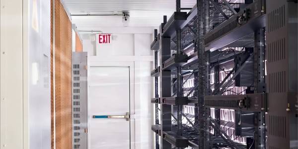 Mining container interior has double-layer water curtains and miner shelves.